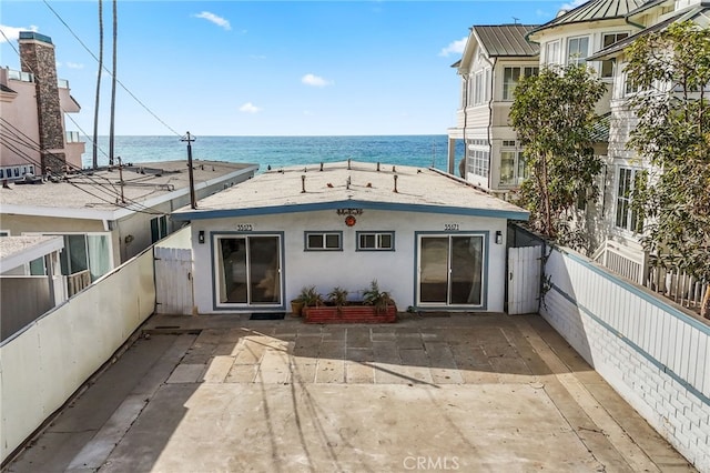 rear view of property with a water view