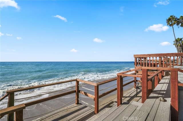 view of home's community featuring a water view and a view of the beach