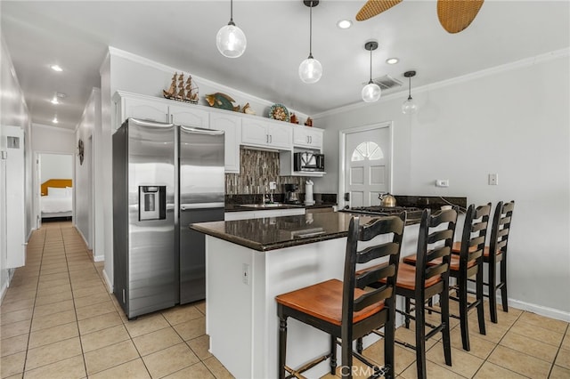 kitchen featuring white cabinetry, a kitchen breakfast bar, stainless steel fridge with ice dispenser, kitchen peninsula, and decorative light fixtures