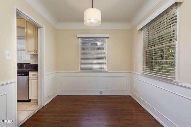 unfurnished dining area with dark wood-type flooring