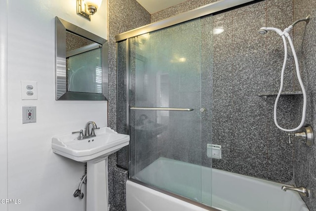 bathroom with sink and enclosed tub / shower combo