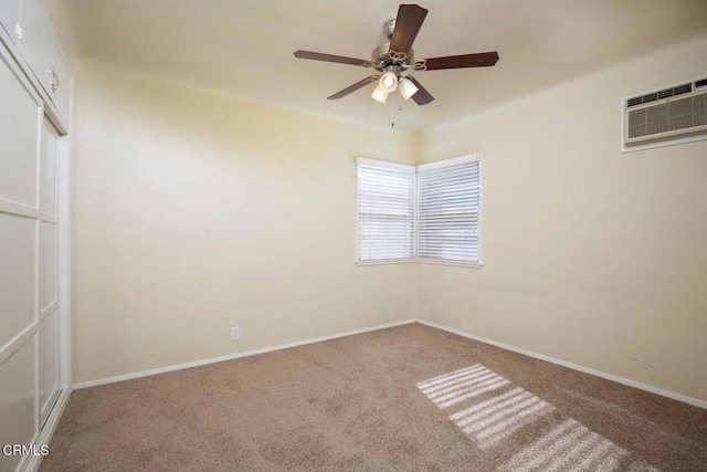 spare room with carpet, an AC wall unit, and ceiling fan