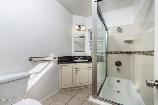 bathroom featuring toilet, vanity, and tile patterned floors