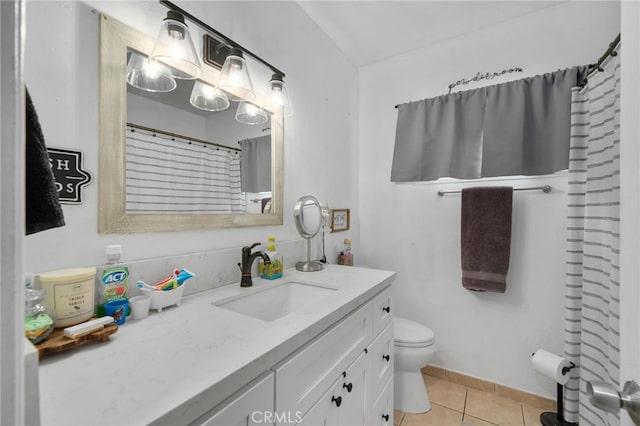 bathroom featuring tile patterned flooring, vanity, and toilet