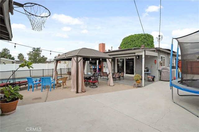 view of patio / terrace featuring a gazebo and a trampoline