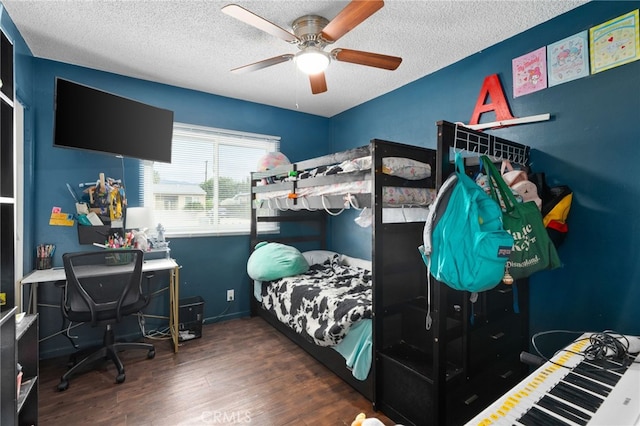 bedroom with ceiling fan, dark wood-type flooring, and a textured ceiling