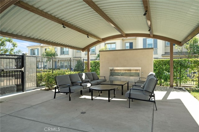 view of patio / terrace with an outdoor living space with a fireplace