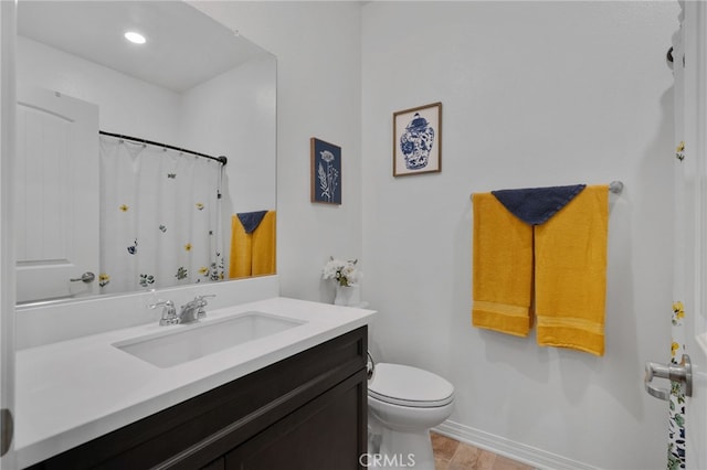 bathroom with a shower with curtain, hardwood / wood-style flooring, vanity, and toilet