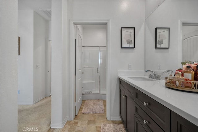 bathroom featuring vanity and a shower with shower door