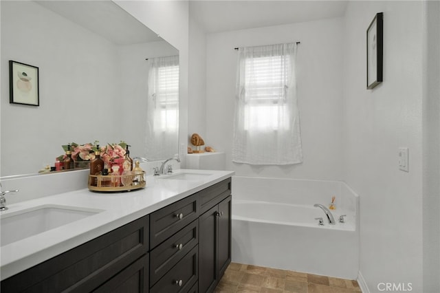 bathroom featuring vanity and a tub to relax in