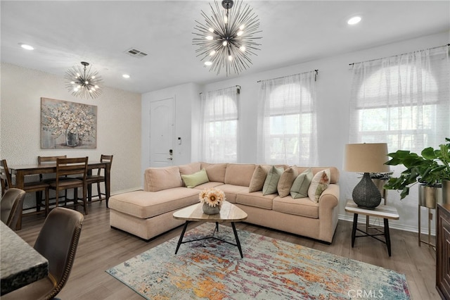 living room featuring wood-type flooring and a chandelier