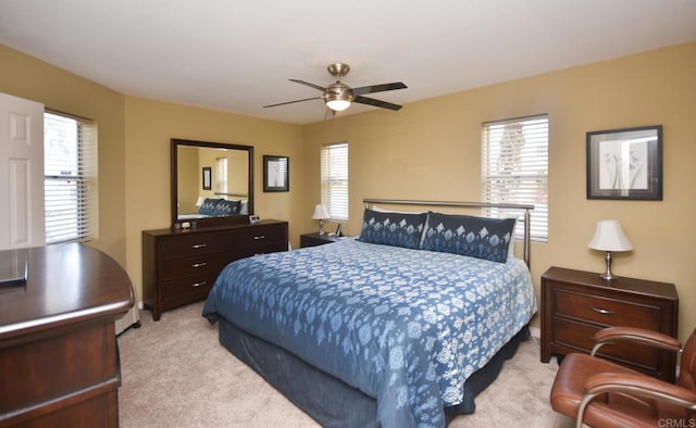 bedroom with light carpet and ceiling fan