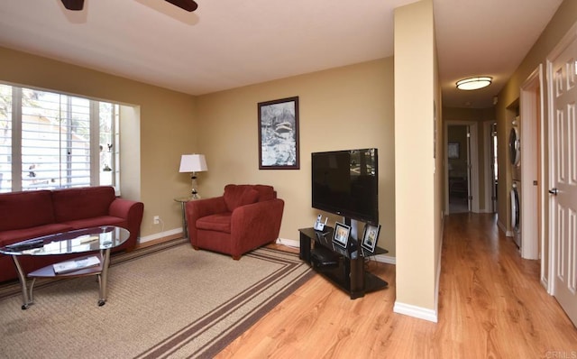 living room featuring ceiling fan and light hardwood / wood-style floors