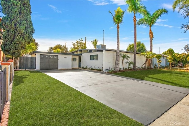 single story home featuring a garage and a front lawn