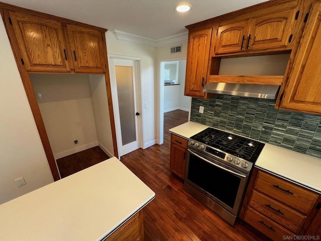 kitchen with stainless steel range, dark hardwood / wood-style flooring, backsplash, crown molding, and extractor fan