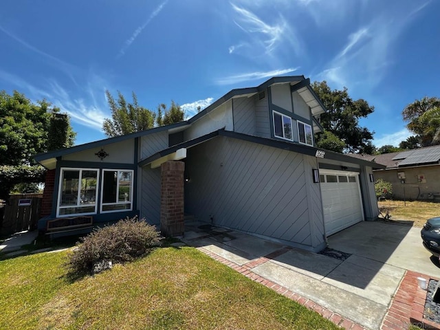 view of front of property featuring a garage and a front lawn