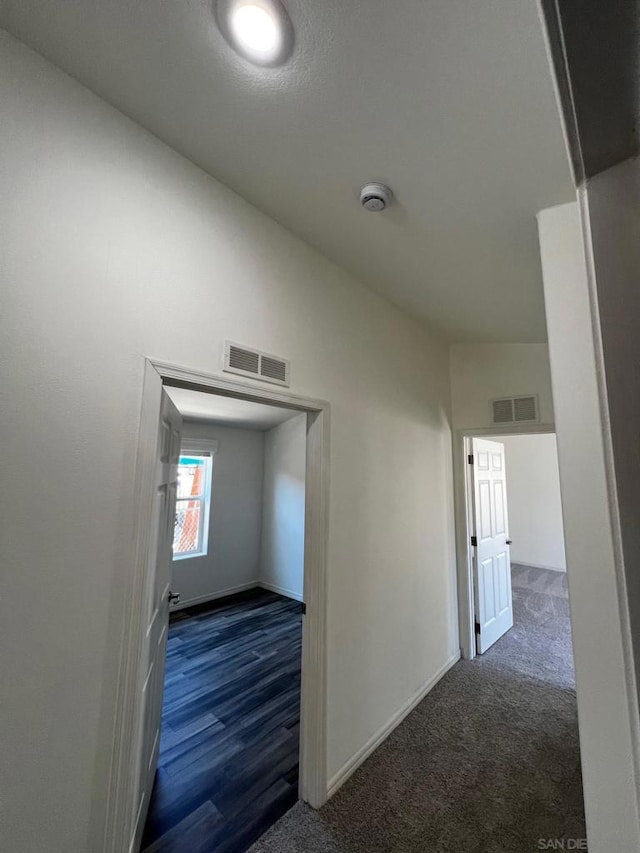 hallway featuring dark hardwood / wood-style flooring