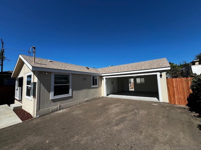 ranch-style house featuring a carport