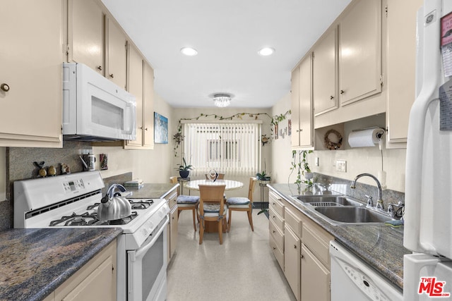 kitchen with white appliances, sink, and cream cabinets