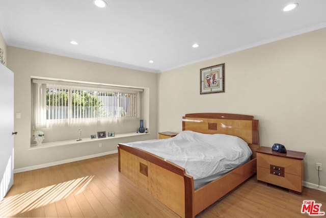 bedroom featuring light hardwood / wood-style flooring and ornamental molding