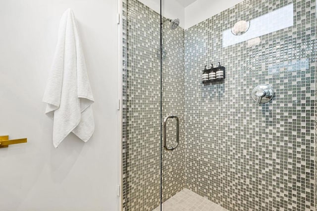 bathroom with a shower with shower door