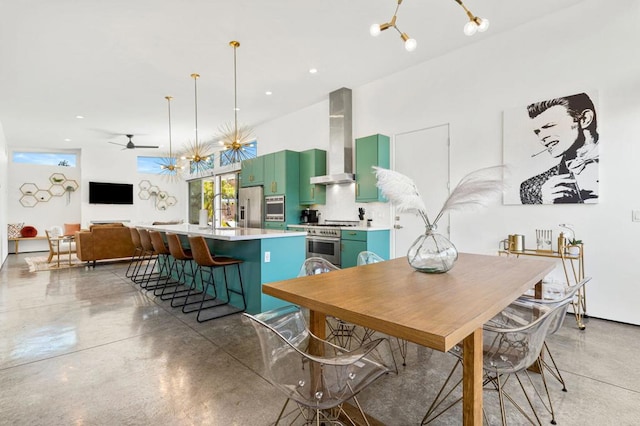 dining area with concrete flooring and ceiling fan