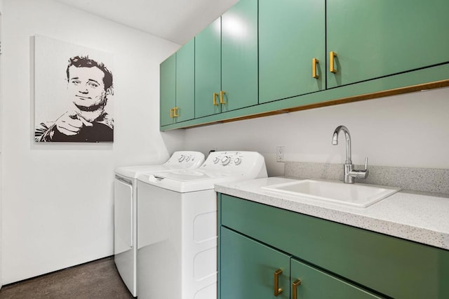 laundry area featuring cabinets, washing machine and dryer, and sink