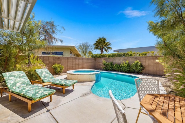 view of pool with an in ground hot tub and a patio