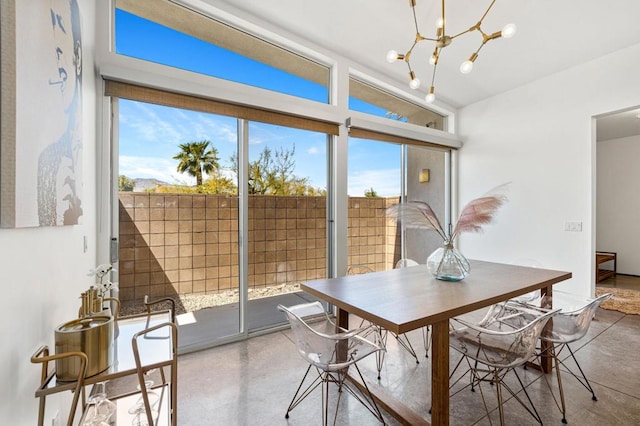 sunroom featuring a chandelier and plenty of natural light