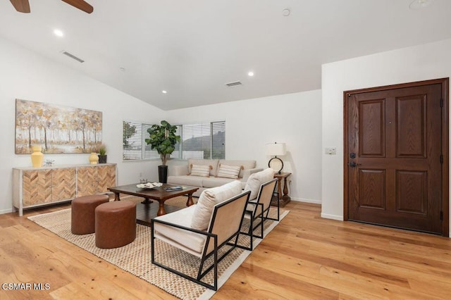 living room with light wood-type flooring, ceiling fan, and lofted ceiling