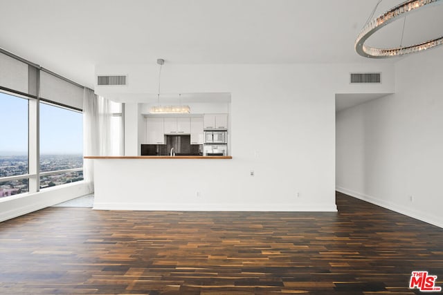 unfurnished living room featuring dark hardwood / wood-style floors