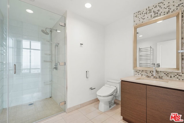 bathroom featuring backsplash, walk in shower, vanity, tile patterned flooring, and toilet