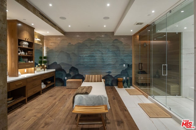 bathroom with vanity, an enclosed shower, and wood-type flooring