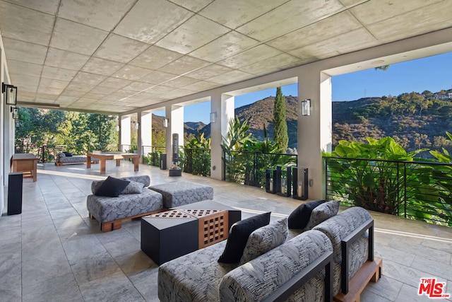 view of patio / terrace with a mountain view and an outdoor hangout area