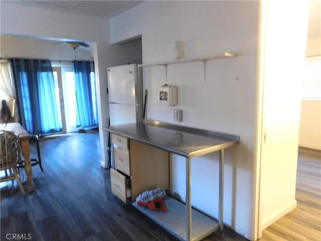 kitchen with white fridge and hardwood / wood-style flooring