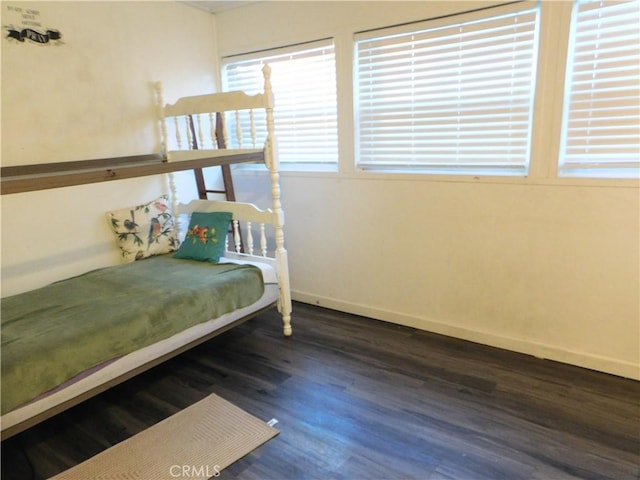 unfurnished bedroom featuring dark wood-type flooring