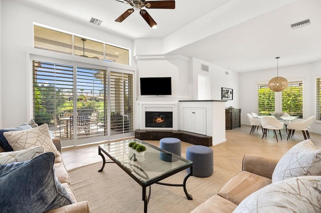 living room featuring ceiling fan and light parquet floors