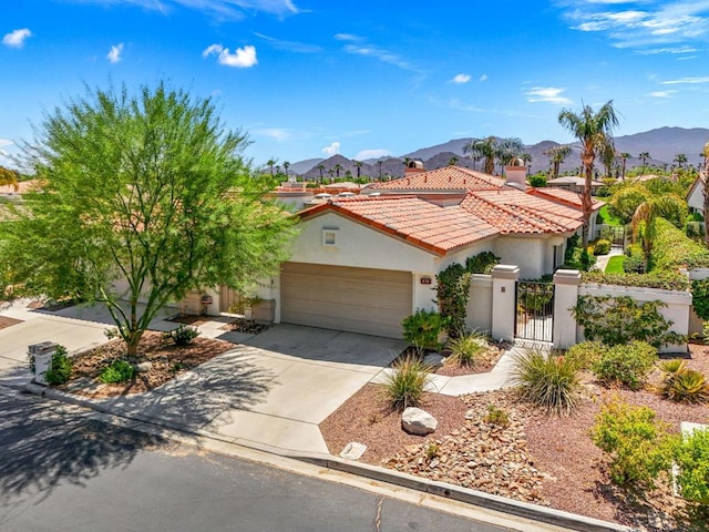 view of front of house featuring a mountain view and a garage