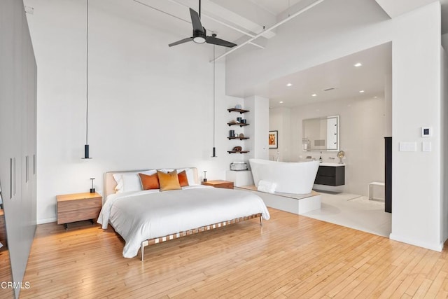 bedroom with light hardwood / wood-style floors and ceiling fan