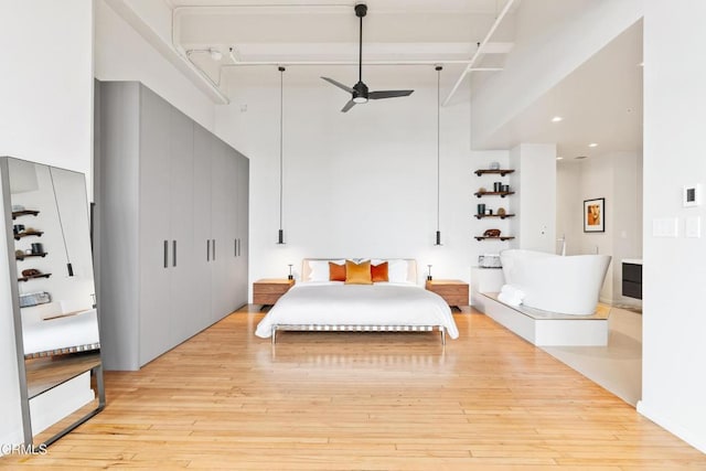 bedroom featuring light hardwood / wood-style flooring and ceiling fan