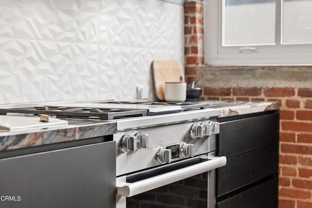 interior details featuring white cabinetry and high end stainless steel range