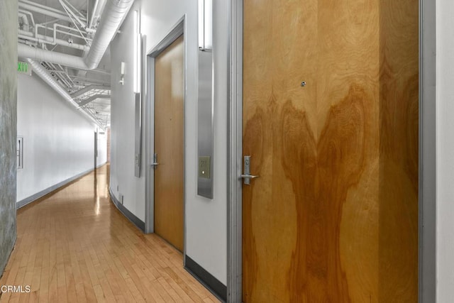 corridor with light hardwood / wood-style flooring