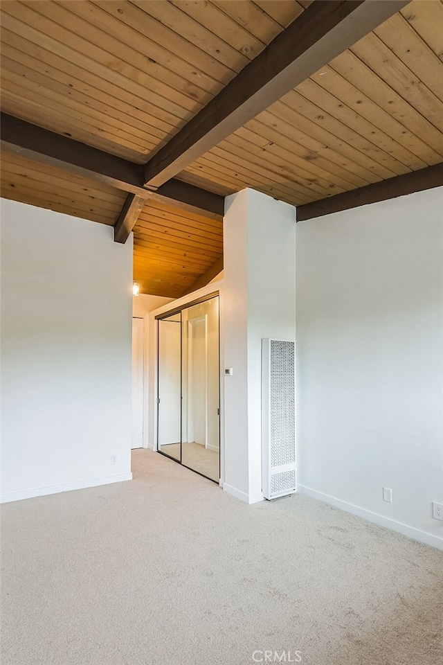 empty room with light carpet, vaulted ceiling with beams, and wooden ceiling