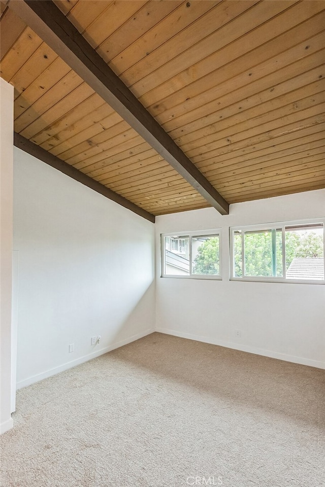 carpeted spare room with vaulted ceiling with beams and wooden ceiling