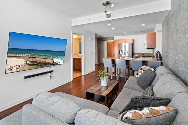 living room with dark hardwood / wood-style flooring and sink