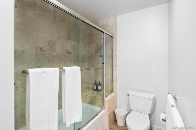 bathroom featuring toilet and enclosed tub / shower combo