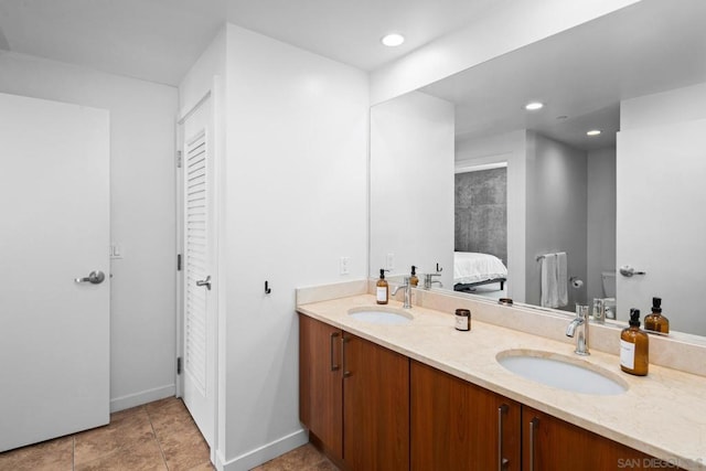 bathroom featuring toilet, vanity, and tile patterned floors