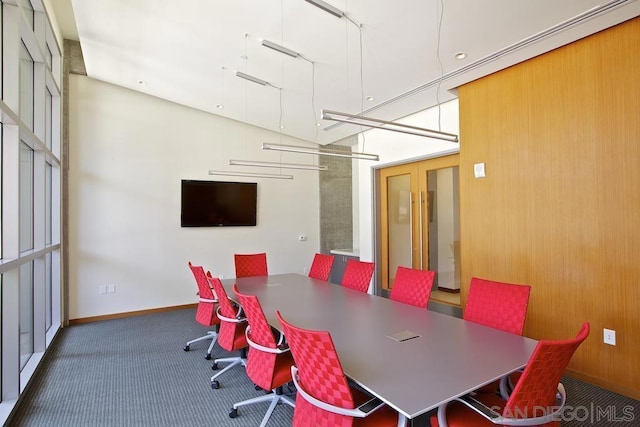 dining space featuring dark carpet