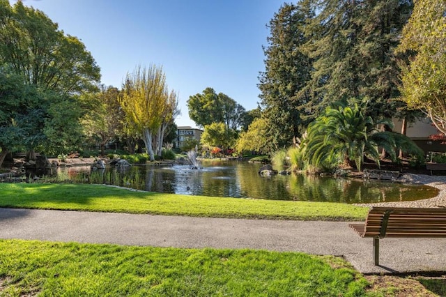 view of community featuring a yard and a water view