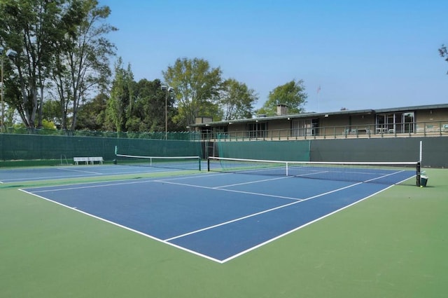 view of tennis court featuring basketball court